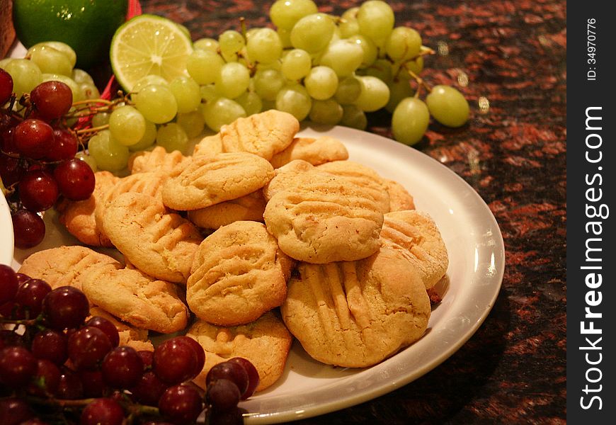 Cookies surrounded by grapes and other fruits. Cookies surrounded by grapes and other fruits.