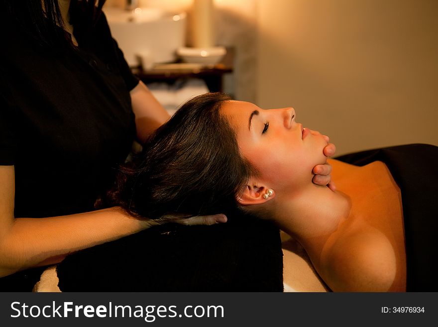 Woman receiving a face massage during spa treatment. Woman receiving a face massage during spa treatment.