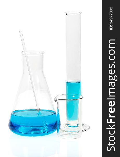 Laboratory glassware with blue liquid on white