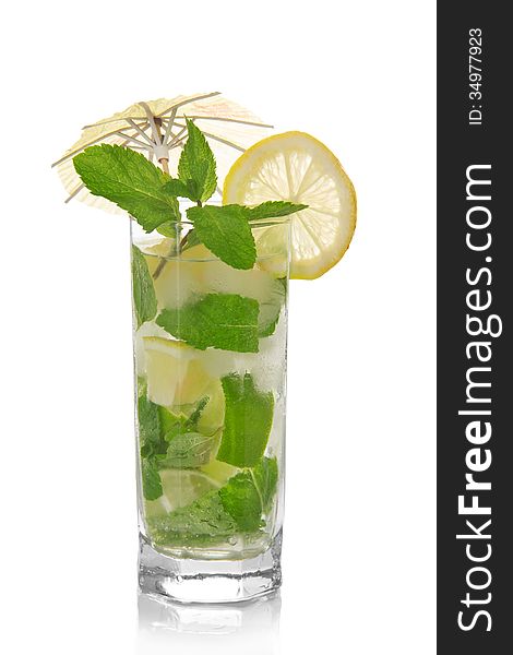 Mojito, is decorated with an umbrella and a slice of lemon and spearmint isolated on white