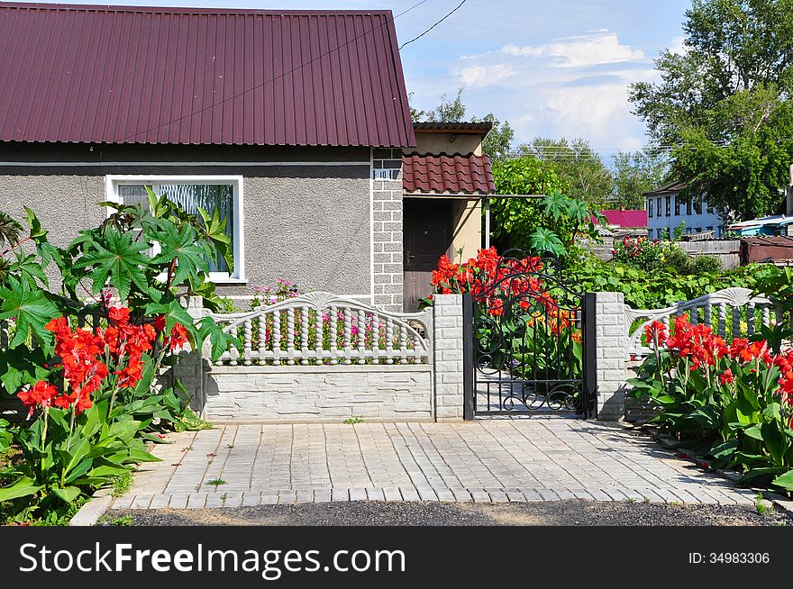 Beautiful home in the summer, decorated with red flowers