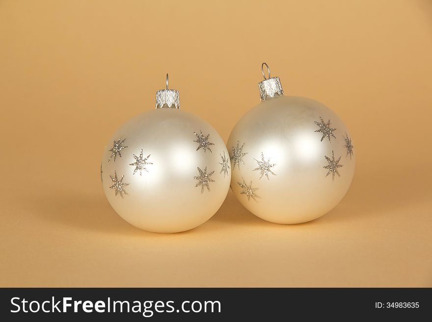 Two beautiful Christmas toys on a beige background