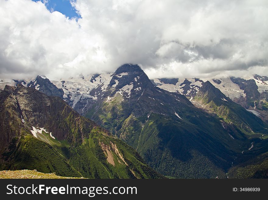 Mountain peaks in Dombai. Summer in cloudy weather