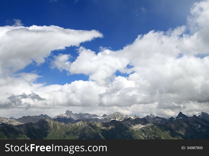 Mountain peaks in Dombai. Summer in cloudy weather