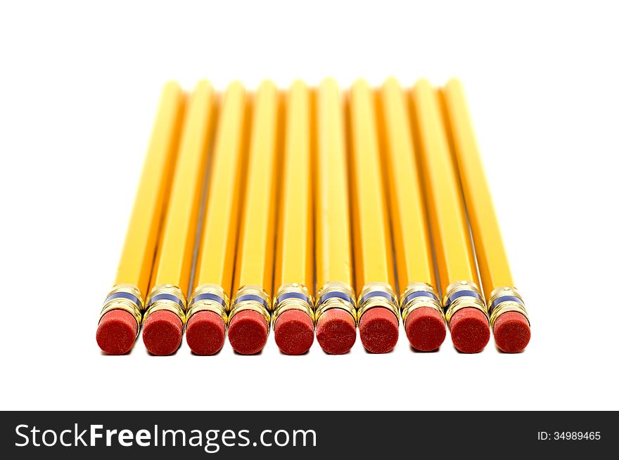 Row Of Yellow Pencils With Erasers In Foreground