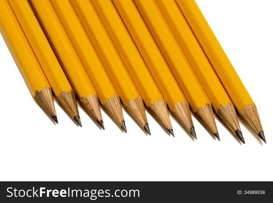 Overhead, close up shot of sharpened pencils with shadows and isolated on white with shadows. Horizontal shot. Overhead, close up shot of sharpened pencils with shadows and isolated on white with shadows. Horizontal shot.