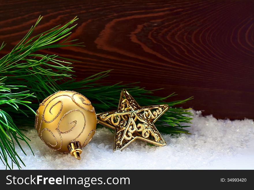 Fir-tree twig decorated with a ball and a star