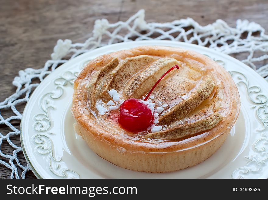 Apple cake with cream cheese and cinnamon, decorated with cherry