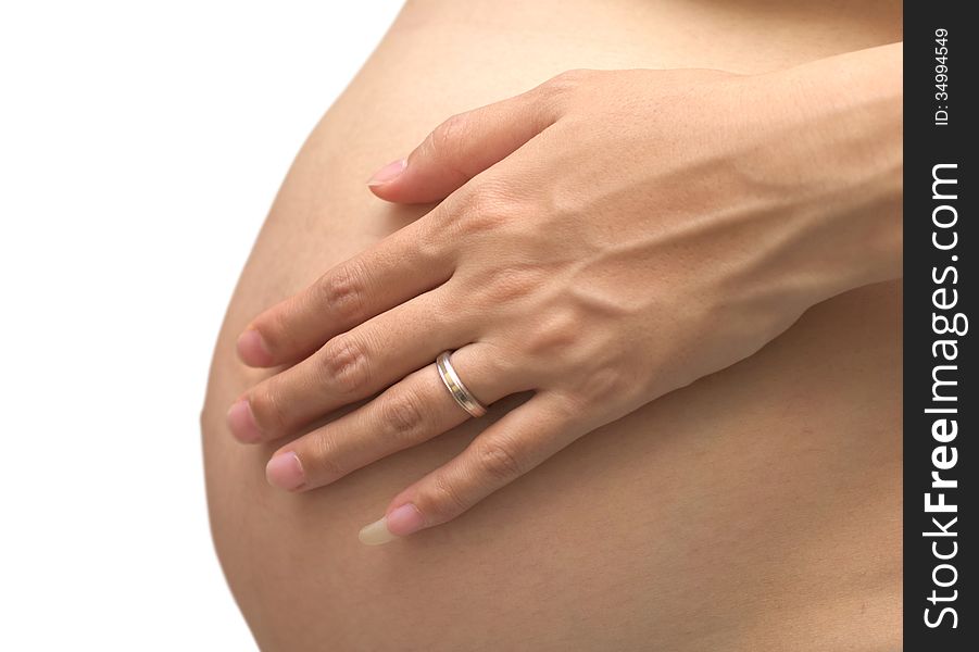 Belly and hands of the pregnant woman on white background