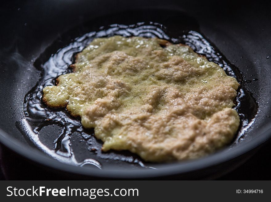 Potato pancake in a frying pan
