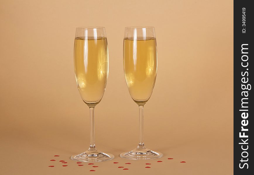 Two Wine Glasses Of Champagne And Small Hearts On