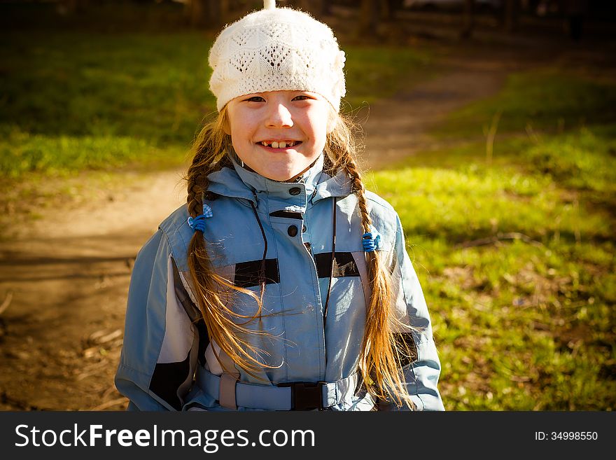 The healthy little girl smiling, walks in park in the autumn. The healthy little girl smiling, walks in park in the autumn