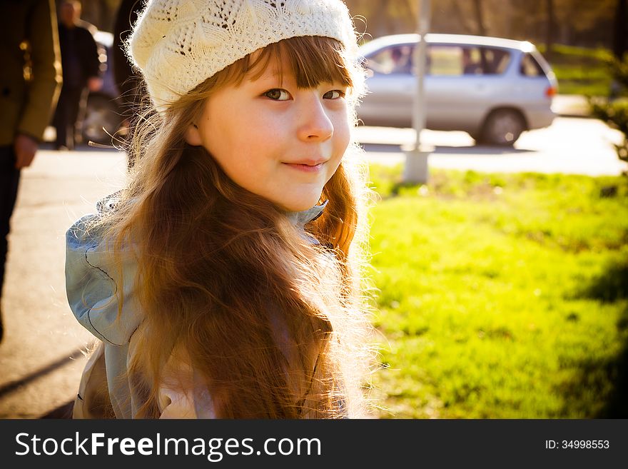 Little girl in park in the autumn