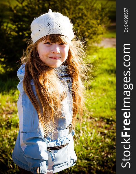 The healthy little girl smiling, walks in park in the autumn. The healthy little girl smiling, walks in park in the autumn