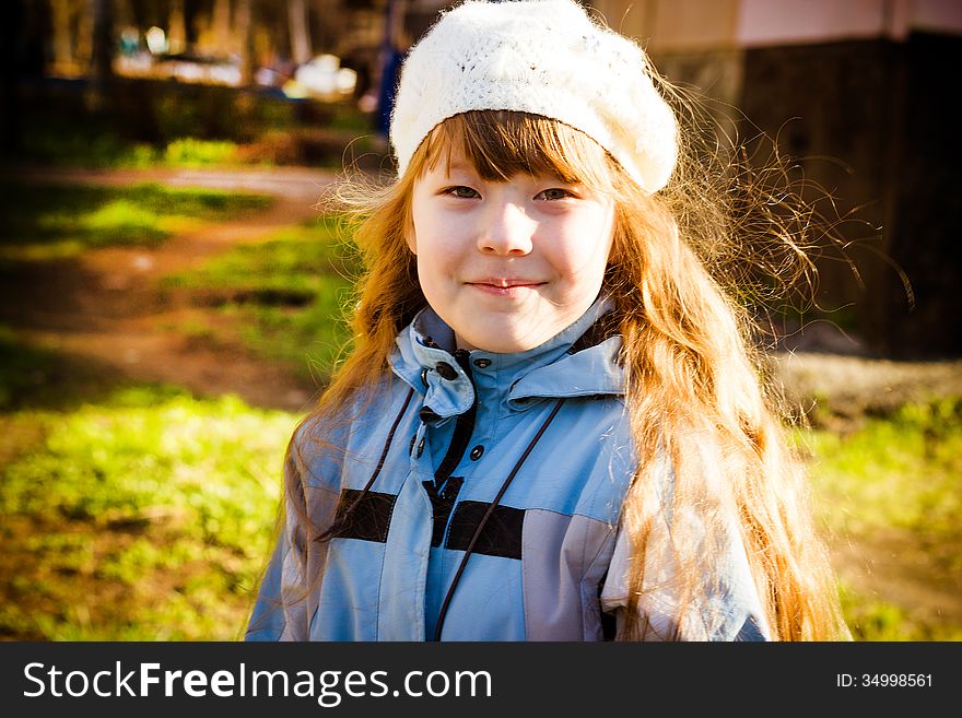 The healthy little girl smiling, walks in park in the autumn. The healthy little girl smiling, walks in park in the autumn