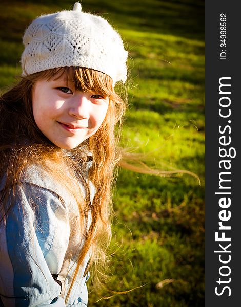 The healthy little girl smiling, walks in park in the autumn. The healthy little girl smiling, walks in park in the autumn