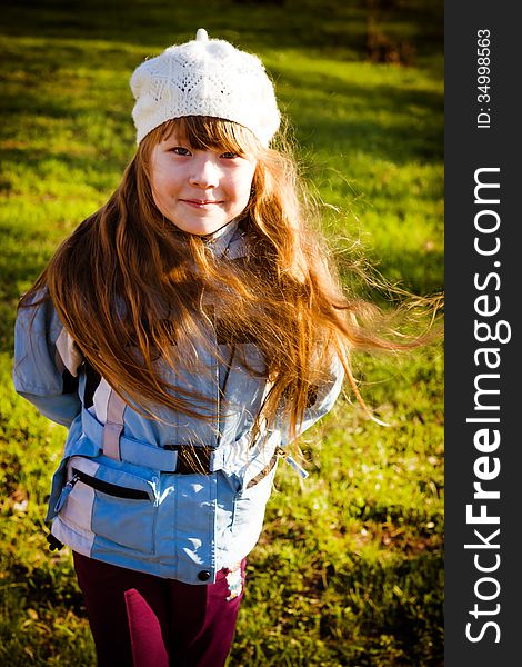 The healthy little girl smiling, walks in park in the autumn. The healthy little girl smiling, walks in park in the autumn