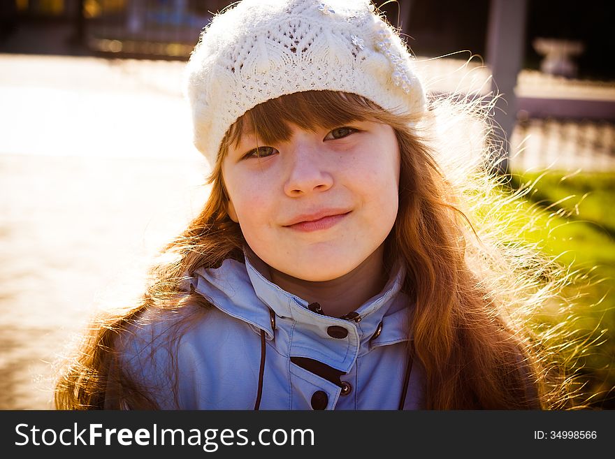 The healthy little girl smiling, walks in park in the autumn. The healthy little girl smiling, walks in park in the autumn