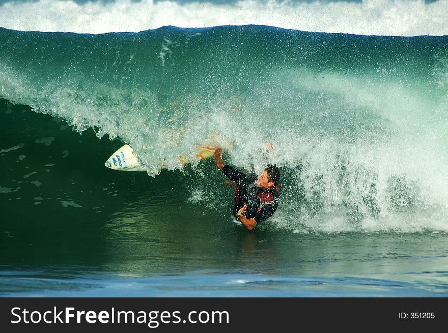 Surfer going under the wave break. Surfer going under the wave break