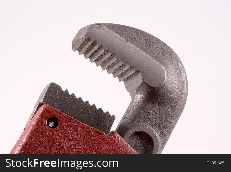 Horizontal view of a close up of a Monkey Wrench showing the teeth of the jaws on the upper part of the wrench. Horizontal view of a close up of a Monkey Wrench showing the teeth of the jaws on the upper part of the wrench