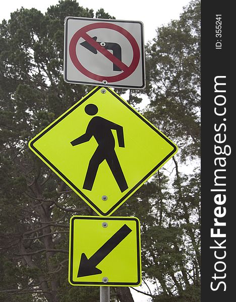 A roadsign warns cars of pedestrians at the top of a blind hill. A roadsign warns cars of pedestrians at the top of a blind hill.