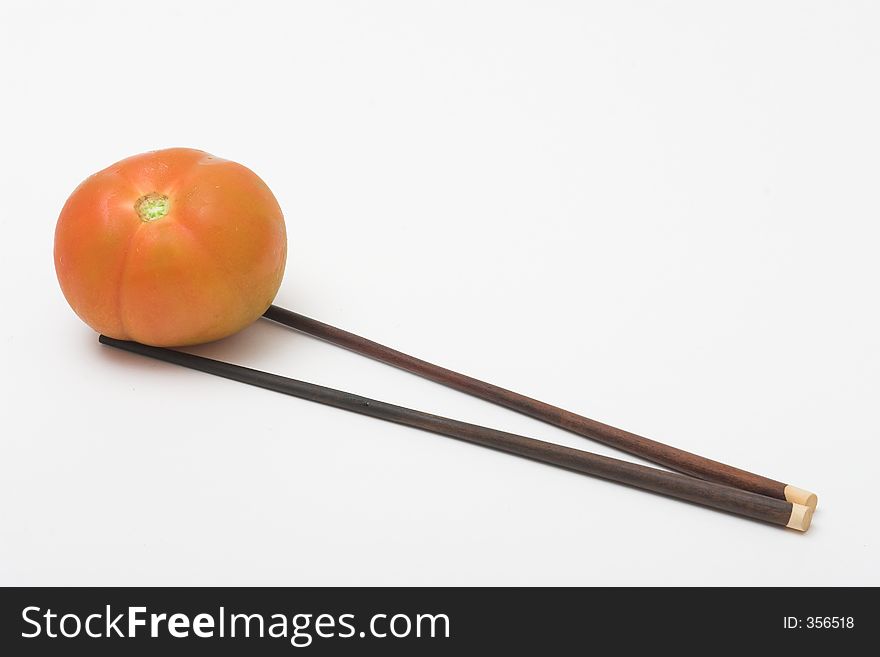 Red tomato with a couple of chopstick. Red tomato with a couple of chopstick