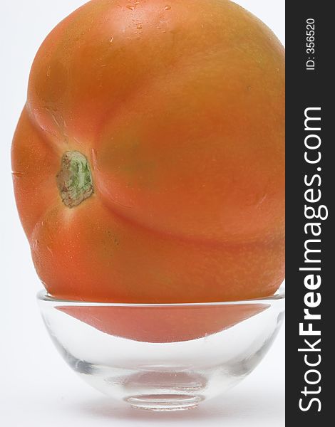 Red fresh tomato in a glass cup. Red fresh tomato in a glass cup