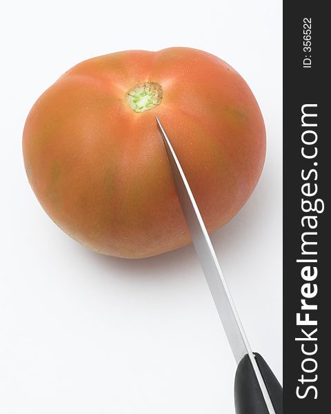 Knife Cutting A Tomato