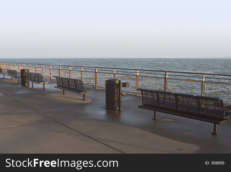 Metal benches overlook the water of San Francisco Bay. Metal benches overlook the water of San Francisco Bay.