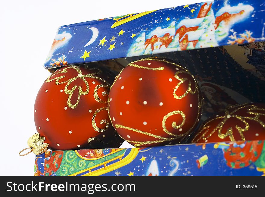 Open gift box with red balls inside isolated. Open gift box with red balls inside isolated