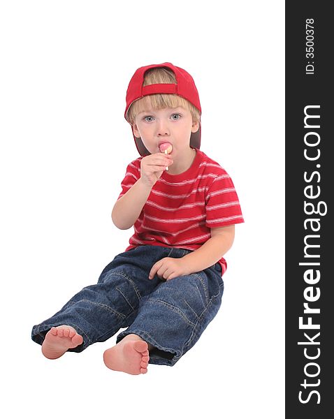 A toddler boy enjoying a lollipop.