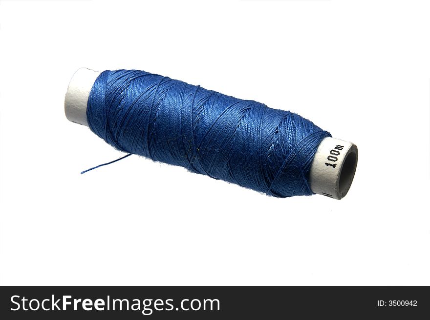 Isolated spool of bluee cotton thread. Isolated spool of bluee cotton thread.