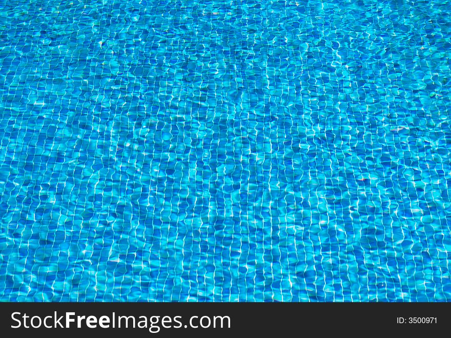 Water rippling in a pool. Bright blue water background. Water rippling in a pool. Bright blue water background.