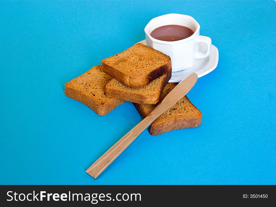 Cup of coffe and slices of bread with knife