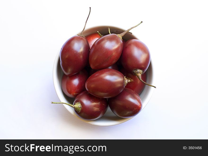 A bowl of juicy ripe red tamarillo fruit. A bowl of juicy ripe red tamarillo fruit