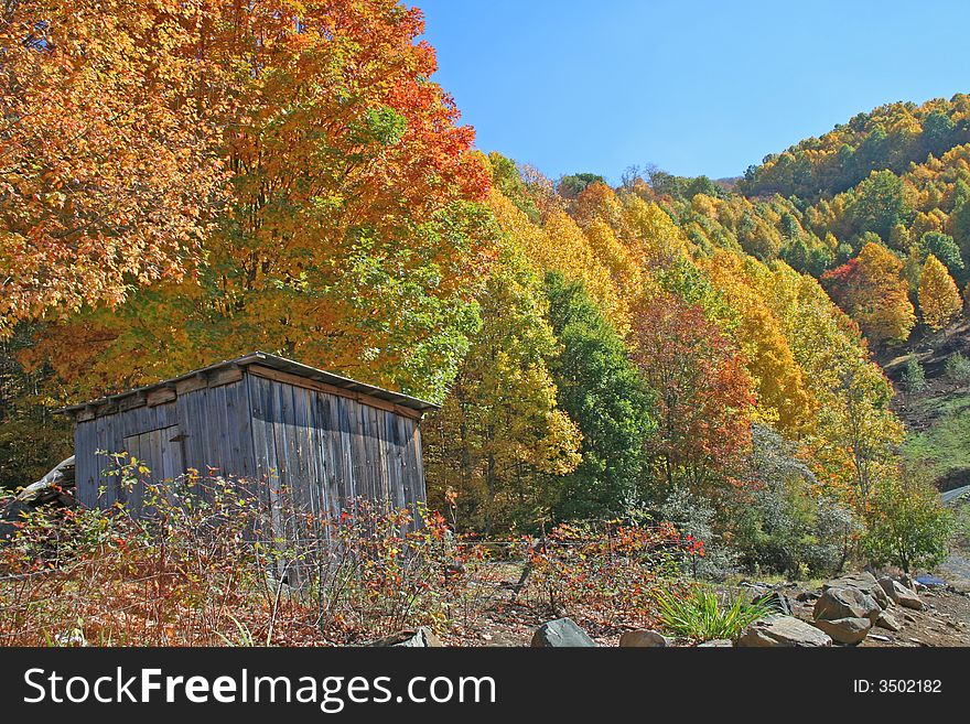 Colorful autumn mountain scene with rustic out building. Colorful autumn mountain scene with rustic out building