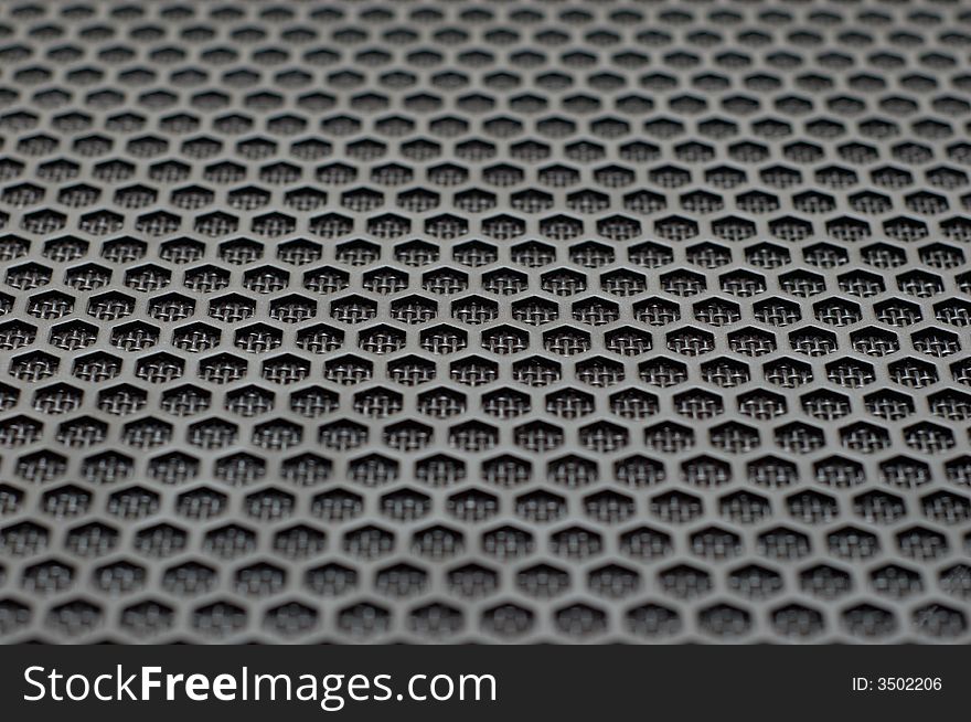 Background of hexagonal pattern of speaker grille. selective focus.