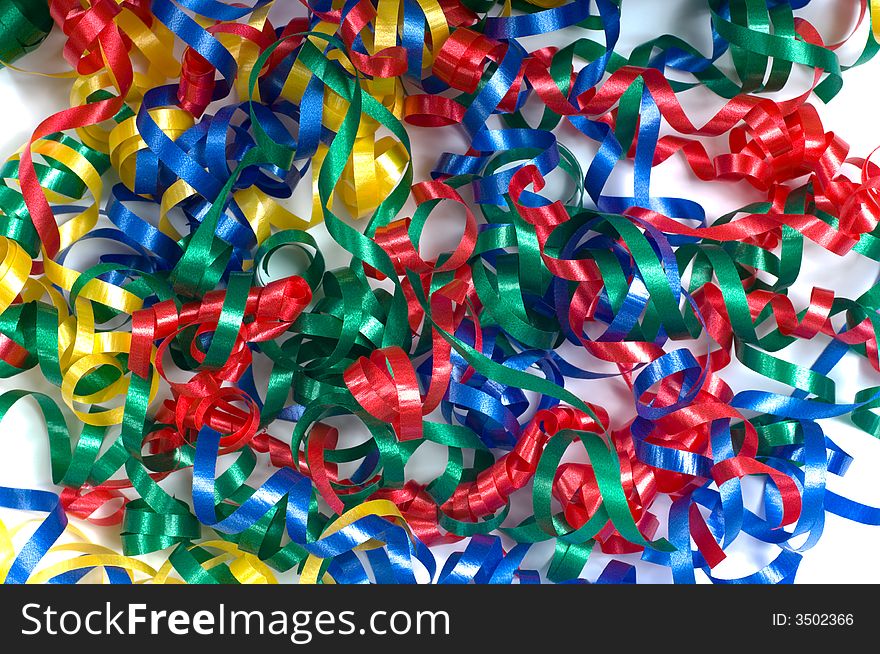 A background consisting of primary colored curly ribbons in a pile on a white background, can be used for an announcement of any kind of celebration, new years, birthday etc. A background consisting of primary colored curly ribbons in a pile on a white background, can be used for an announcement of any kind of celebration, new years, birthday etc.