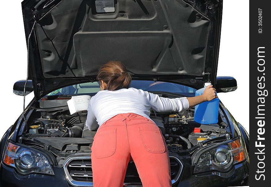 Attractive woman in red jeans trying to fix the car with a manual book. Attractive woman in red jeans trying to fix the car with a manual book