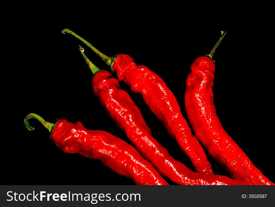 Red Hot chili peppers on black background