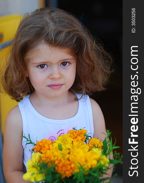 Beautiful girl with face expression, yellow flowers in hand. Beautiful girl with face expression, yellow flowers in hand