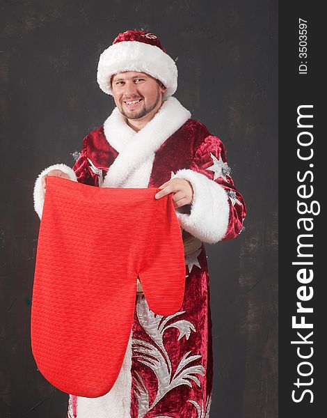 An image of smiling Santa with red bag