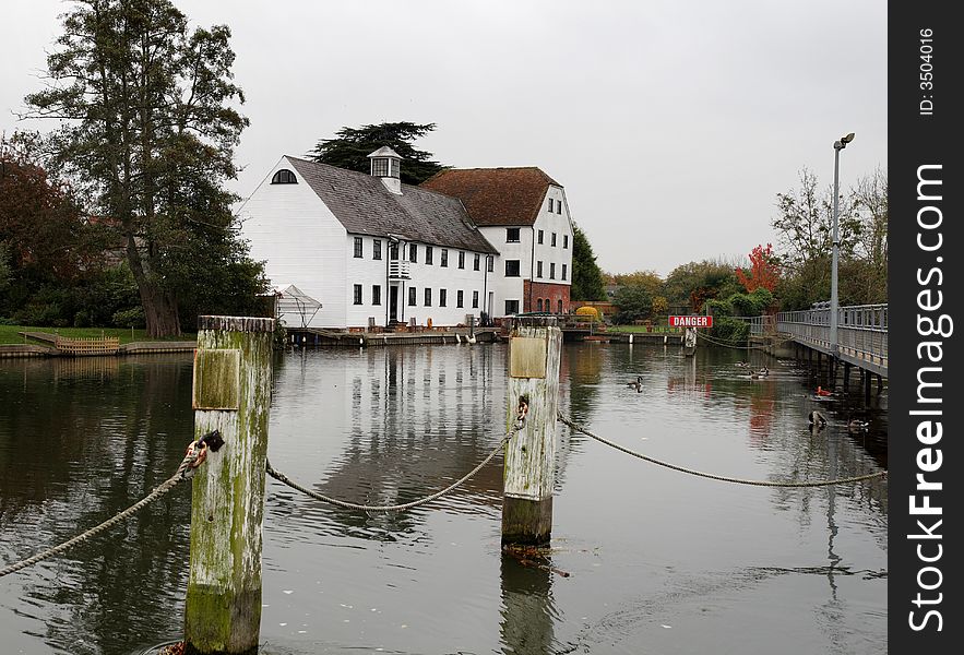 Autumn scene of an Historic Mill on the River Thames in England with Canada Geese in the foreground