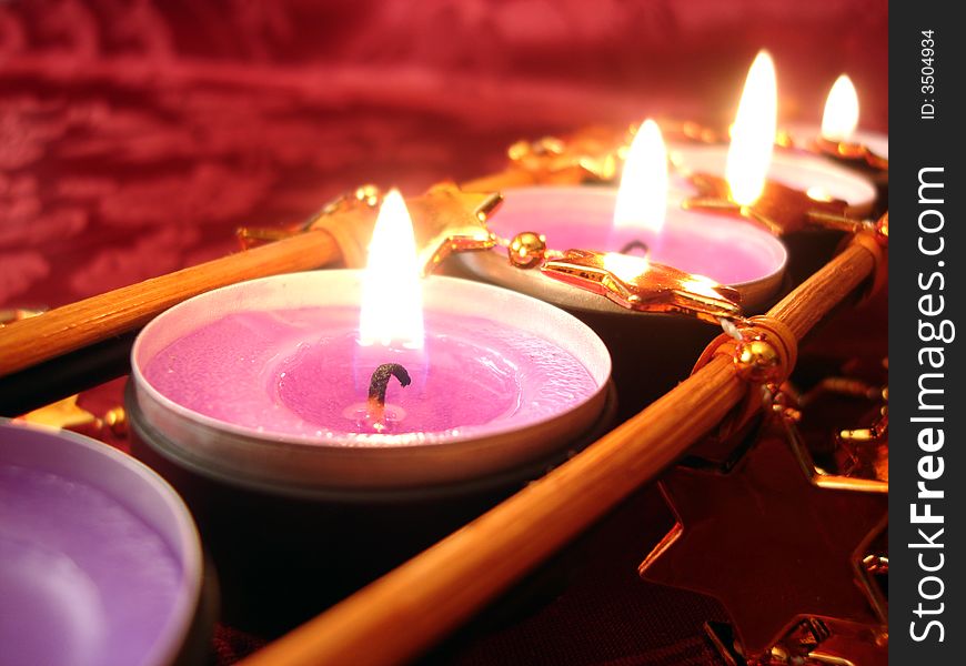 Row of pink candles with stars, close-up