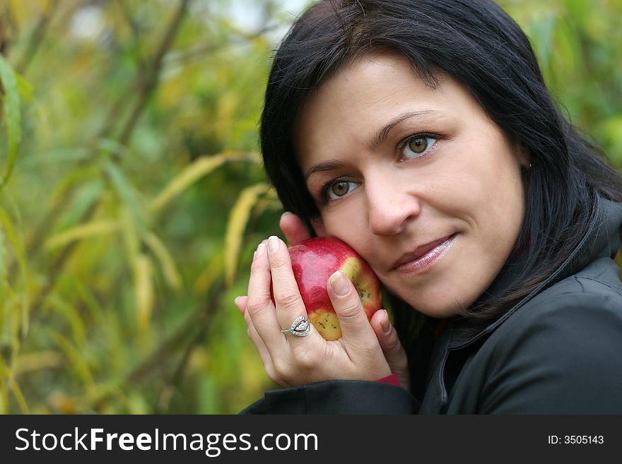 Woman And Apple In Autumn Park