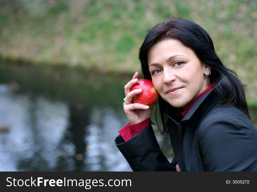 Black head woman and apple in autumn park