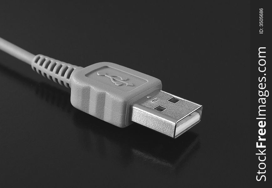 Usb cable with plug close-up fragment at the black background. Usb cable with plug close-up fragment at the black background