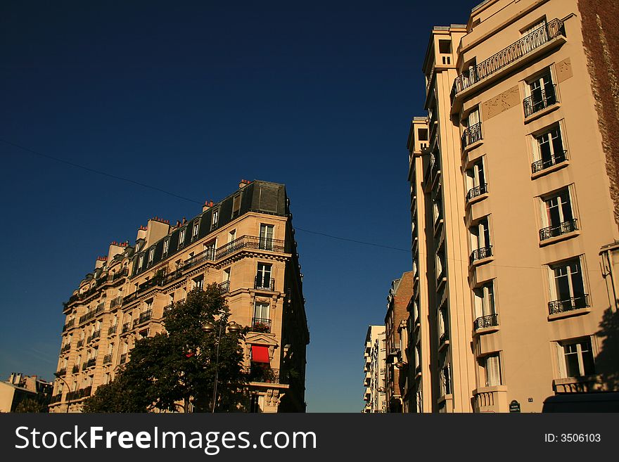 Corner of usual streets of Paris at the morning light and with a totally blue sky as background. Corner of usual streets of Paris at the morning light and with a totally blue sky as background