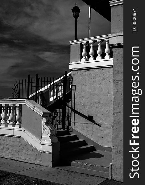 The back portion of an aging condominium building against a black and white sky. The back portion of an aging condominium building against a black and white sky