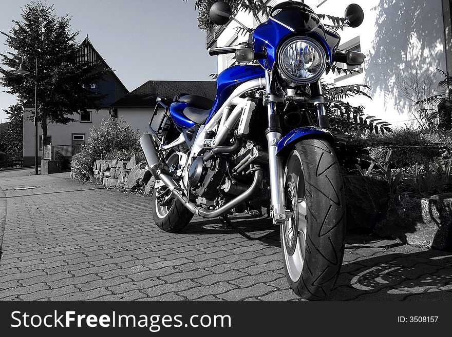 Blue motorcycle with black and white backround